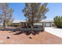 Charming single-story home with a well-maintained front yard and attached two-car garage at 5981 Doubletree Rd, Pahrump, NV 89061