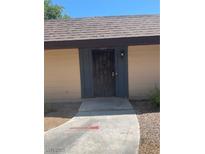 Charming front entrance featuring a secure black gate and concrete pathway at 6162 Meadow Vista Ln, Las Vegas, NV 89103