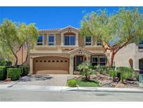 Charming two-story home featuring a well-manicured lawn, mature trees, and a two-car garage at 6564 Baroque Ave, Las Vegas, NV 89139