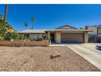 Charming single-story home featuring a two-car garage and desert landscaping at 6616 Celeste Ave, Las Vegas, NV 89107