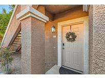 Inviting front entrance featuring a decorated door and well-maintained stucco exterior with a porch light at 830 Carnegie St # 512, Henderson, NV 89052