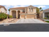 Charming two-story home with a tile roof and attached three-car garage, set in a desert landscape at 8605 Trianon Ln, Las Vegas, NV 89145