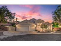 Beautiful home exterior featuring a 3-car garage and a desert landscaped yard at dusk at 1145 Glacier Park Ct, Henderson, NV 89052