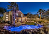 Stunning backyard oasis featuring a sparkling pool, lush landscaping, and cozy outdoor seating area at 1246 Diamond Valley St, Henderson, NV 89052