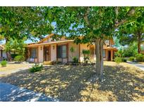 Charming one-story home featuring desert landscaping and a mature shade tree in the front yard at 1372 Lorilyn Ave # 3, Las Vegas, NV 89119