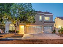 Charming two-story home featuring a manicured front yard and attached two-car garage at 1968 Evening Glow Dr, Las Vegas, NV 89134