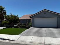 Charming home with a two-car garage, landscaped yard, and easy-to-maintain artificial grass at 3601 Slapton Ave, North Las Vegas, NV 89031