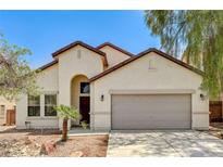 Charming single-story home featuring a two-car garage and desert landscaping at 3609 Blue Pimpernel Ave, North Las Vegas, NV 89081