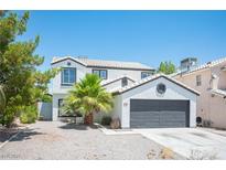 Charming two-story home featuring a well-manicured yard, a two car garage, and crisp white paint at 6524 Rain Forest Dr, Las Vegas, NV 89108