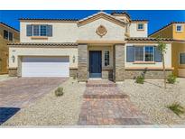 Charming two-story home featuring a stone entryway, two-car garage, and a well-maintained front yard with desert landscaping at 9722 Rocket Grove Ct, Las Vegas, NV 89178