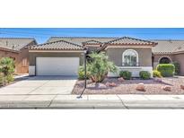 Charming single-story home featuring desert landscaping, a two-car garage and a lovely tiled roof at , Las Vegas, NV 89122