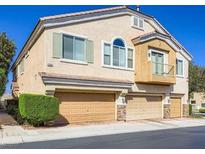 Charming townhome featuring a three-car garage, a quaint balcony, and a well-maintained front yard at 1081 Elation Ln # 2, Henderson, NV 89002