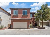 Charming two-story home with a two-car garage and well-maintained landscaping on a sunny day at 10918 Avenzano St, Las Vegas, NV 89141