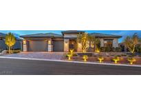 Beautiful single-story home showcasing a spacious driveway and meticulously landscaped yard at 12544 Claymore Highland Ave, Las Vegas, NV 89138