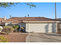 Charming one-story home features a tile roof, low maintenance landscaping, and an attached two-car garage at 159 Coastal Pier Ct, Henderson, NV 89002