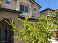 Two-story home featuring a stucco exterior, trimmed windows, and well-maintained landscaping at 248 Crystal Rose Ct, Las Vegas, NV 89106