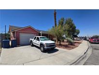 Modest single-story home featuring a driveway, front yard with sparse landscaping, and an attached garage at 2965 Palma Vista Cir, Las Vegas, NV 89169