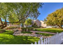 Beautifully landscaped front yard with lush greenery and a charming stone bridge at 5110 N Valadez St, Las Vegas, NV 89149