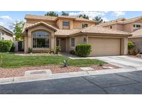 Charming two-story home with manicured lawn, desert landscaping, and a two-car garage at 5452 Desert Spring Rd, Las Vegas, NV 89149