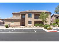 Inviting exterior view of a two-story home with manicured landscaping and convenient parking at 6635 Caporetto Ln # 204, North Las Vegas, NV 89084