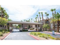 The community entrance features a decorative gate and lush landscaping, giving an inviting feel at 7135 S Durango Dr # 106, Las Vegas, NV 89113