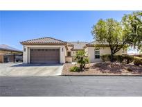 Charming single-story home featuring a tile roof, desert landscaping, and an attached two-car garage at 7286 Mount Kearsarge St, Las Vegas, NV 89131