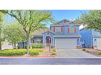 Charming two-story home with blue siding, red shutters, landscaped yard, and a two car garage at 7728 Whispering River St, Las Vegas, NV 89131