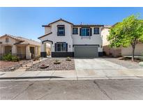 Charming two-story home with a landscaped front yard and a two-car garage in a suburban neighborhood at 8061 Palace Estate Ave, Las Vegas, NV 89117