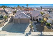Inviting exterior elevation features a well-manicured yard and a spacious three-car garage at 816 Sandsprings St, Henderson, NV 89011