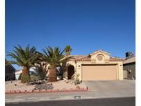 Charming single-story home featuring a two-car garage, desert landscaping, and two mature palm trees at 851 Brahma Ln, Henderson, NV 89002