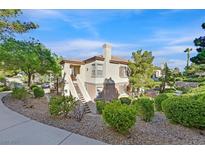 Charming condo with a well-manicured yard and cozy covered staircase leading to the upper level entry at 10205 Camborne Ave # 104, Las Vegas, NV 89144
