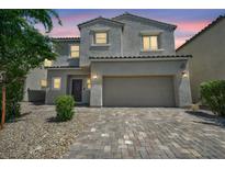 Charming two-story home with a two-car garage and desert landscaping at 2024 Mystic Wave Rd, North Las Vegas, NV 89031