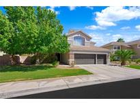 Charming two-story home with a three-car garage and well-maintained front lawn and mature shade trees at 2229 Armacost Dr, Henderson, NV 89074