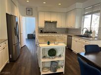 Bright kitchen with white cabinets, stainless steel appliances, and a stylish center island at 2229 Armacost Dr, Henderson, NV 89074