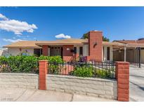 Charming single-story home featuring a well-kept front yard and a classic brick chimney at 2254 Florence Ave, Las Vegas, NV 89119