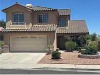 Charming two-story home featuring a two-car garage, desert landscaping, and a tiled roof at 2406 Pebble Springs Ct, Henderson, NV 89074