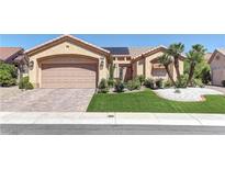 Beautiful single-story home featuring a manicured front yard and two-car garage with brick paver driveway at 2605 Orchid Valley Dr, Las Vegas, NV 89134
