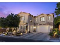 Charming two-story home featuring a stucco exterior, stone accents, and a well-maintained landscape at dusk at 364 Trentino Alto St, Henderson, NV 89012