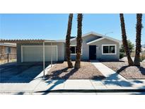 Charming single story home with gray stucco, desert landscaping, and covered parking at 4238 Boratko St, Las Vegas, NV 89115
