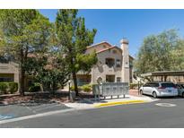 Inviting condo exterior features neutral stucco, covered parking, and mature landscaping at 5415 W Harmon Ave # 2075, Las Vegas, NV 89103