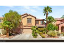 Charming two-story home featuring desert landscaping, mature palm trees, and a two-car garage at 5917 Horsehair Blanket Dr, North Las Vegas, NV 89081