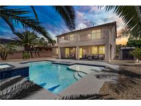 Backyard pool with hot tub and covered patio in a two-story home with wrought iron balcony at 6489 Crest Estates St, Las Vegas, NV 89131