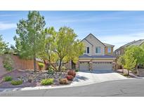 Charming two-story home featuring a three-car garage and a beautifully landscaped front yard with mature trees at 7033 Twin Forks Peak St, Las Vegas, NV 89166