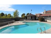 Relaxing community pool with lounge chairs and covered seating area at 761 Bourbon St # 5, Pahrump, NV 89048