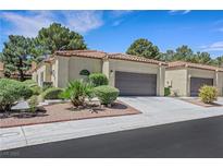 Charming single-story home with a two-car garage, beautiful landscaping, and a tile roof at 7909 Canoe Ln, Las Vegas, NV 89145