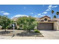 Charming single-story home featuring desert landscaping, a two-car garage, and mature trees in a residential neighborhood at 812 Bitterroot St, Henderson, NV 89002