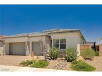 Beautiful single-story home with a two-car garage and desert landscaping at 8934 Windgate Ranch St, Las Vegas, NV 89166
