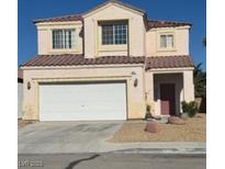 Two story home with a red tile roof, two car garage, and desert landscaping in front at 9612 Flying Eagle Ln, Las Vegas, NV 89123