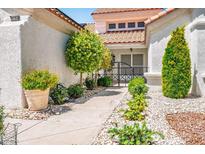Inviting front yard featuring well-maintained landscaping and a secure gated entrance at 9704 Brawley Dr, Las Vegas, NV 89134