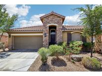 Charming single-story home featuring a stone facade, two-car garage, and drought-tolerant landscaping at 10381 Borah Park Cir, Las Vegas, NV 89178